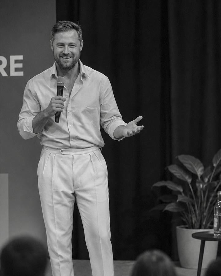 Ben Heath speaking on stage